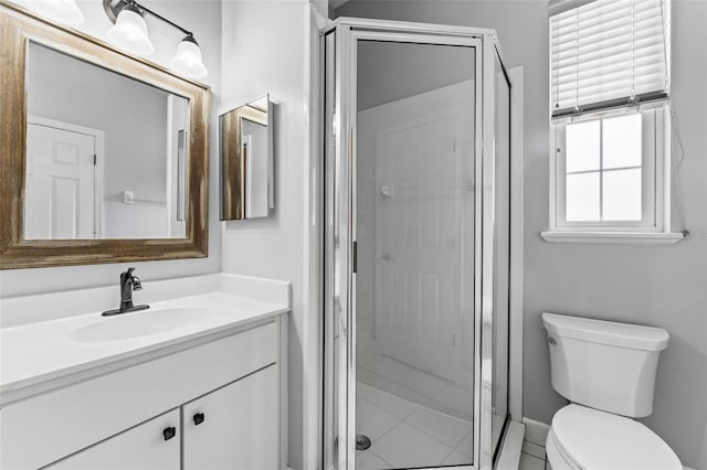 full bathroom with a stall shower, toilet, and vanity