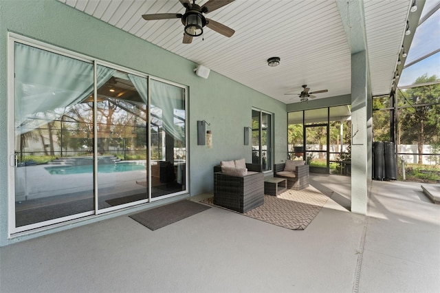 view of patio / terrace featuring an outdoor pool, glass enclosure, ceiling fan, and outdoor lounge area