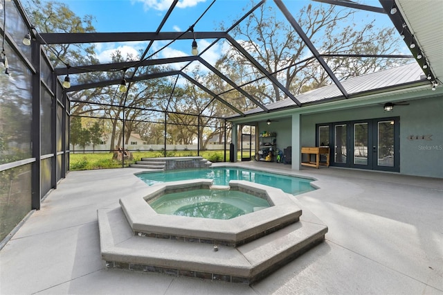 view of pool featuring glass enclosure, a patio, a ceiling fan, and french doors