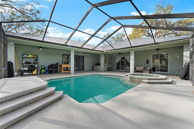 view of swimming pool with glass enclosure, a patio, a ceiling fan, a pool with connected hot tub, and french doors