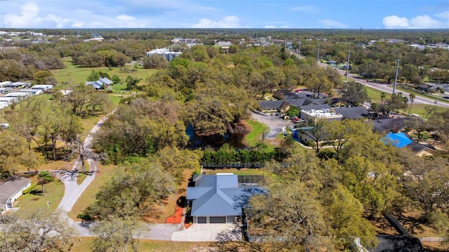 birds eye view of property featuring a view of trees