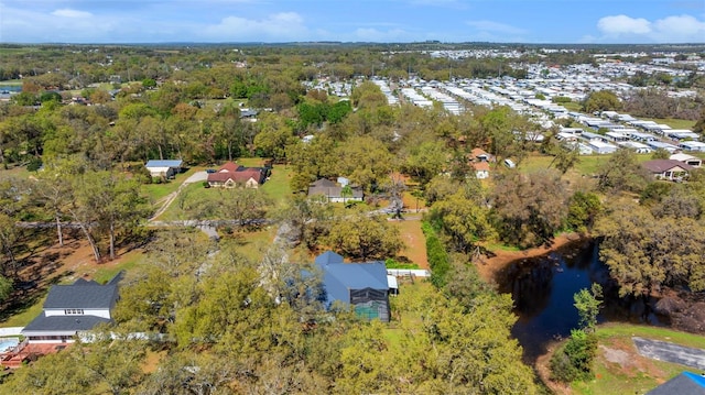 drone / aerial view featuring a residential view and a water view