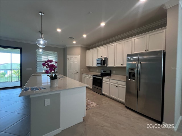 kitchen featuring visible vents, white cabinetry, appliances with stainless steel finishes, a center island, and crown molding