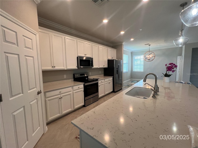 kitchen with visible vents, appliances with stainless steel finishes, ornamental molding, white cabinetry, and a sink