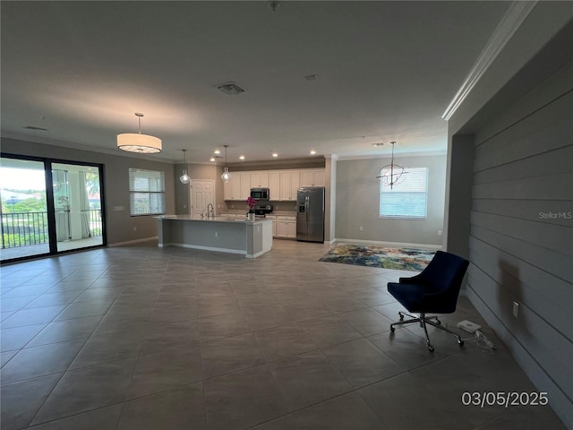 unfurnished living room with ornamental molding, visible vents, and baseboards