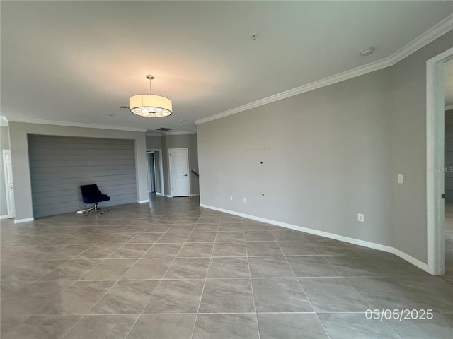 unfurnished living room featuring baseboards, ornamental molding, and tile patterned floors