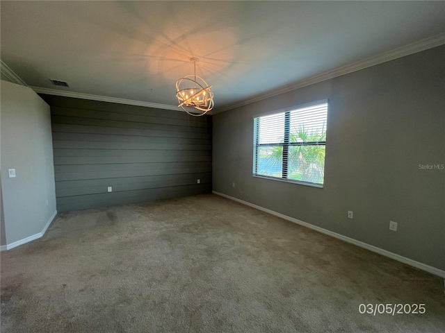 carpeted empty room featuring a chandelier, baseboards, visible vents, and crown molding