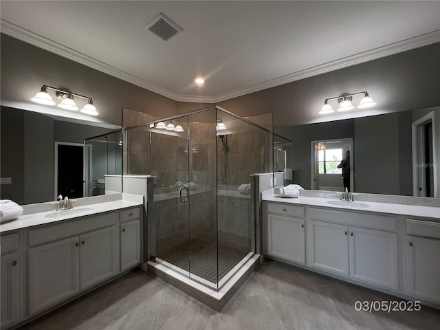 full bath featuring ornamental molding, a stall shower, a sink, and visible vents