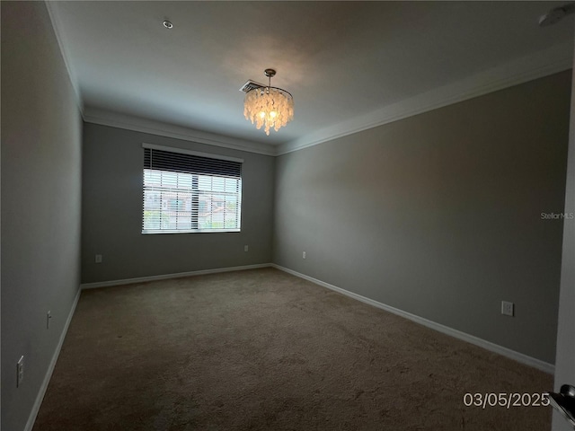 spare room featuring ornamental molding, carpet, and an inviting chandelier