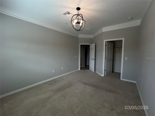 unfurnished bedroom featuring a chandelier, carpet flooring, visible vents, baseboards, and crown molding