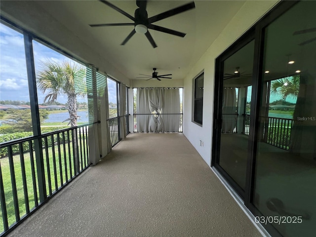 sunroom featuring a water view