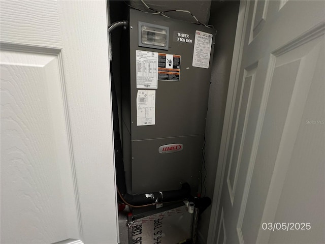 utility room featuring heating unit