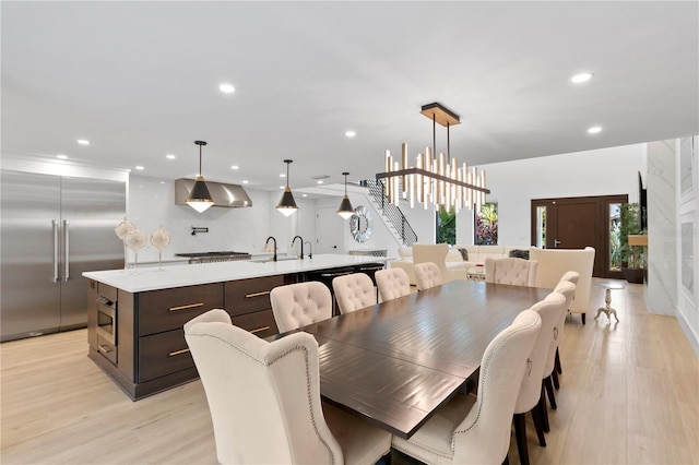 dining room featuring recessed lighting, a notable chandelier, and light wood-style floors