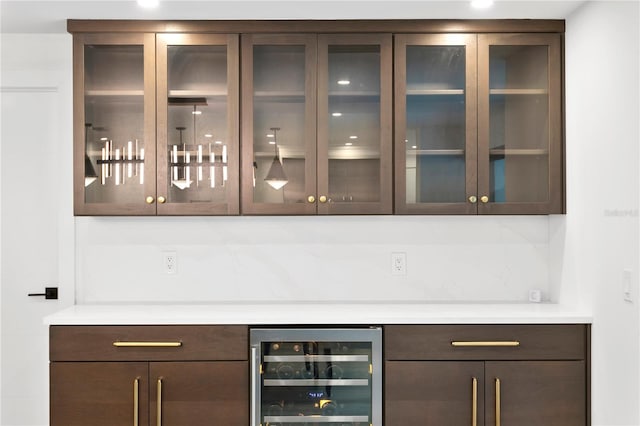 bar featuring wine cooler, backsplash, and a dry bar