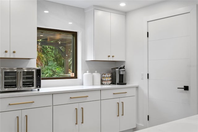 kitchen with light countertops, white cabinets, and a toaster