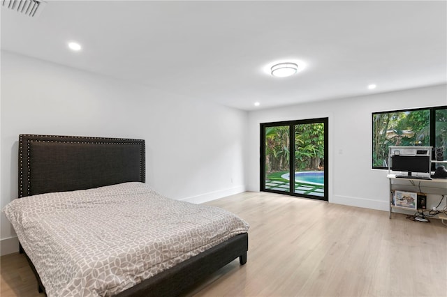 bedroom with access to exterior, light wood-style flooring, baseboards, and visible vents