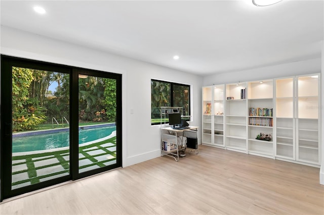 entryway featuring recessed lighting, wood finished floors, and baseboards