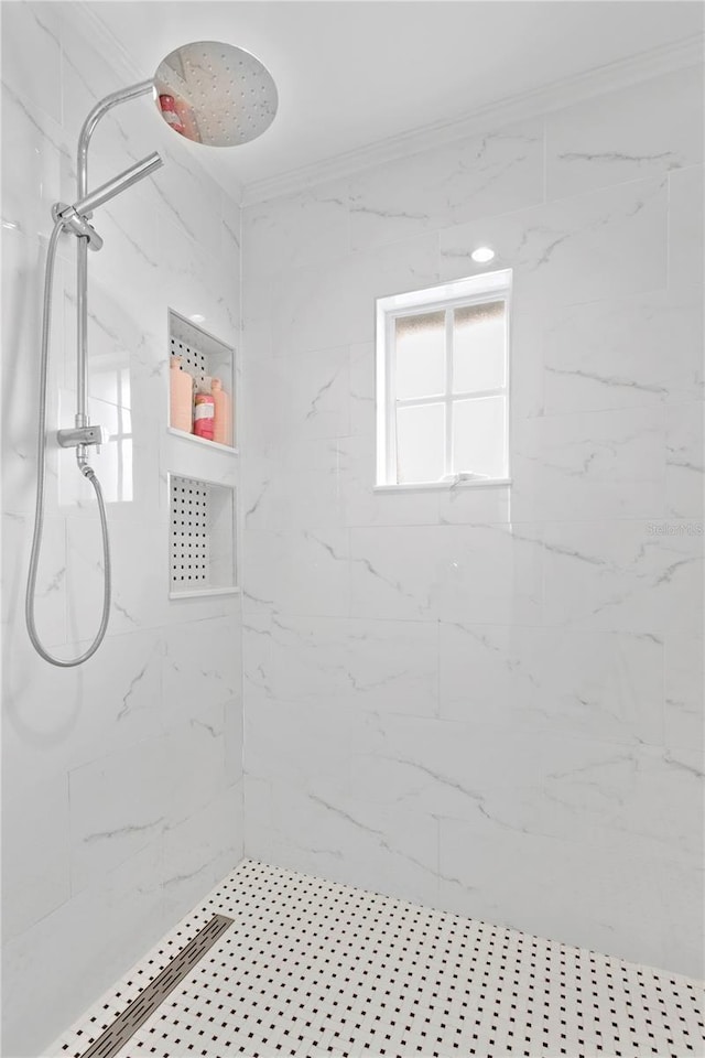 bathroom featuring crown molding and a marble finish shower