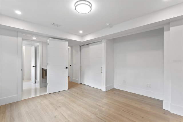 below grade area featuring visible vents, recessed lighting, light wood-type flooring, and baseboards