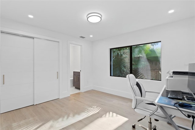 office featuring recessed lighting, visible vents, baseboards, and wood finished floors