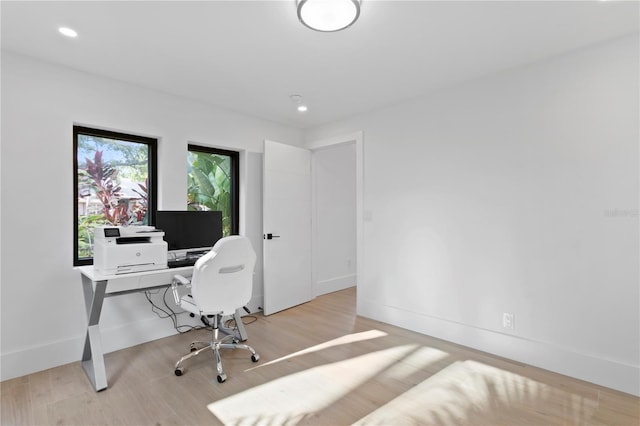 home office with recessed lighting, light wood-style flooring, and baseboards