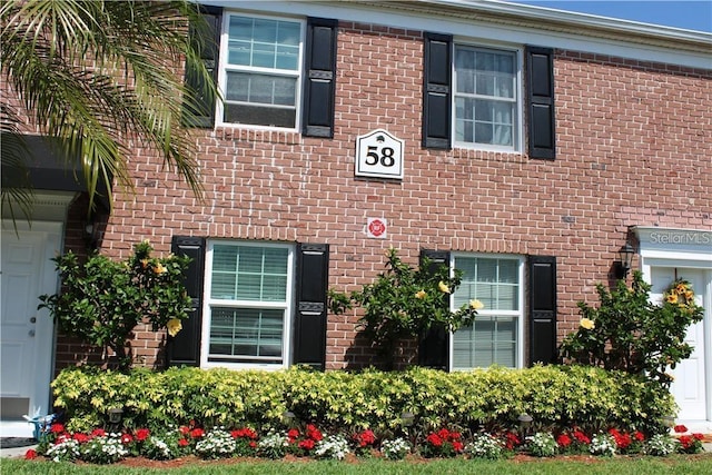 exterior space featuring brick siding