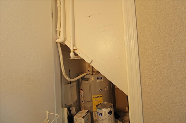 utility room featuring water heater