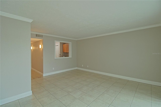 empty room with baseboards, visible vents, ornamental molding, a textured ceiling, and light tile patterned flooring