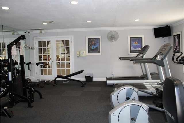 workout area with a textured ceiling, visible vents, baseboards, french doors, and crown molding