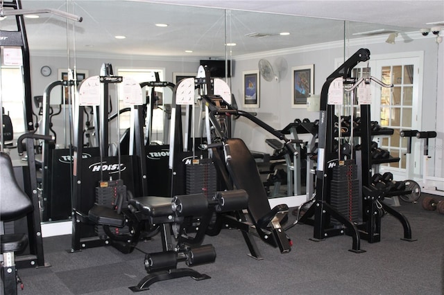 exercise room with ornamental molding and recessed lighting