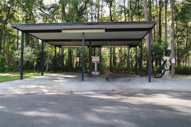 view of parking featuring a carport and aphalt driveway