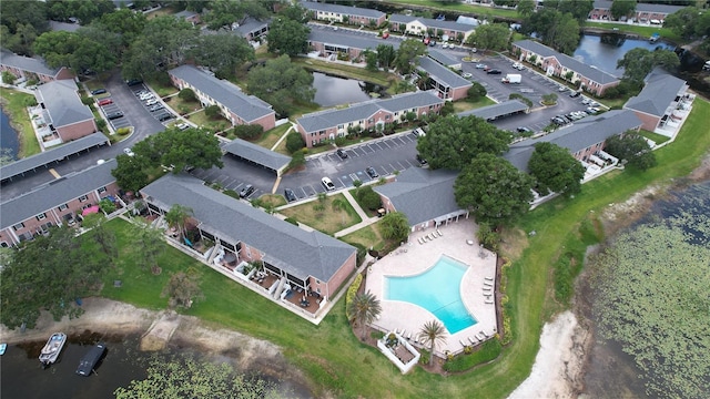 birds eye view of property with a water view and a residential view