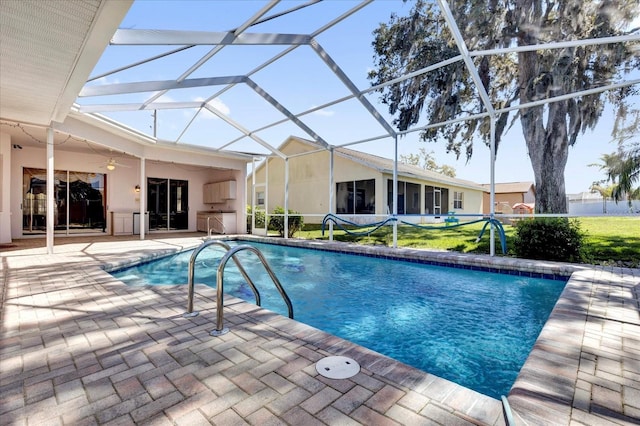 pool featuring ceiling fan, a patio, and a lanai