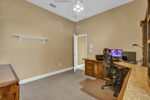 home office featuring a ceiling fan, visible vents, light carpet, and baseboards