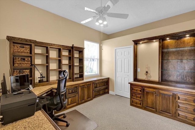 office with light carpet and ceiling fan