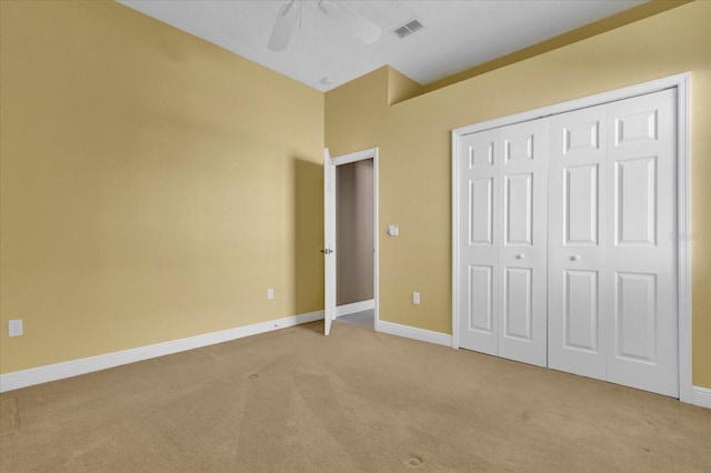 unfurnished bedroom featuring ceiling fan, carpet flooring, visible vents, baseboards, and a closet