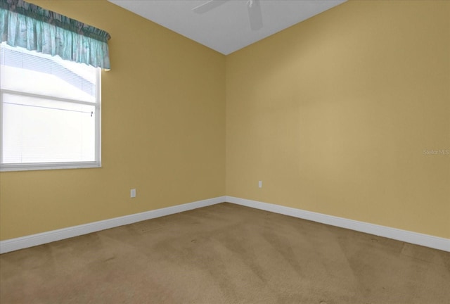 unfurnished room featuring ceiling fan, carpet flooring, and baseboards