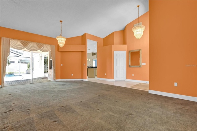 unfurnished living room featuring carpet floors, high vaulted ceiling, and baseboards