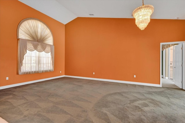 carpeted empty room featuring a chandelier, lofted ceiling, visible vents, and baseboards