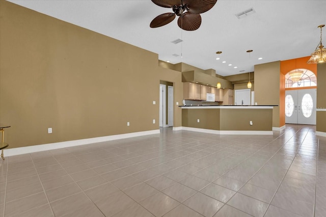 unfurnished living room with french doors, visible vents, baseboards, and light tile patterned floors