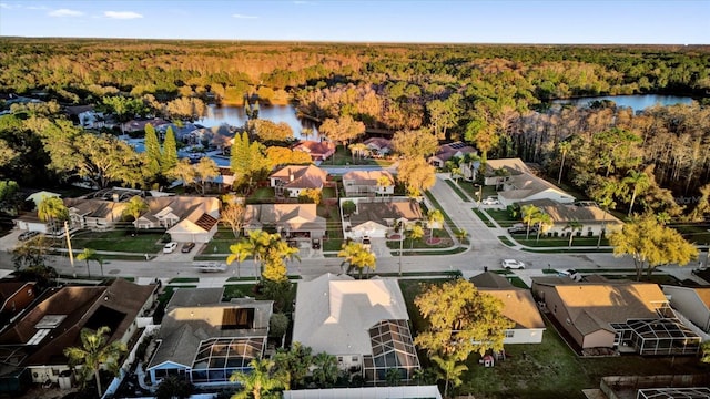 bird's eye view with a residential view, a water view, and a view of trees