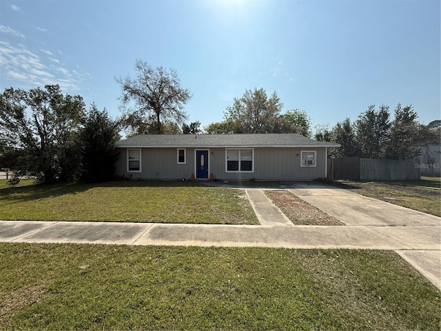 single story home with a front yard and fence