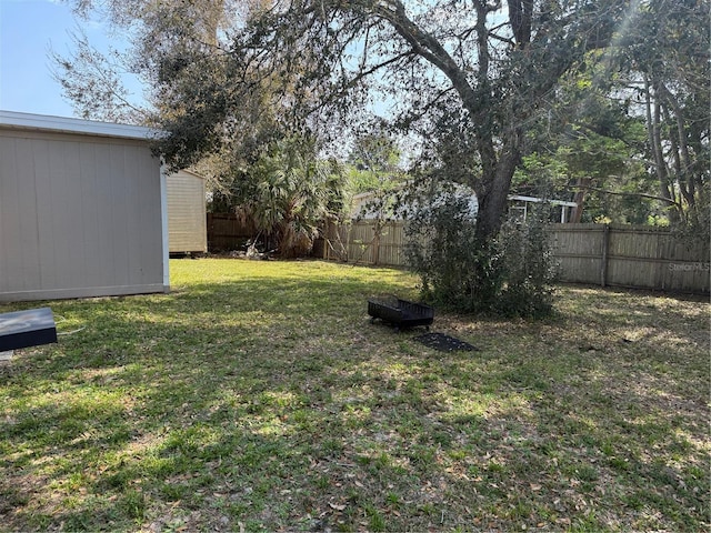 view of yard with an outbuilding and a fenced backyard