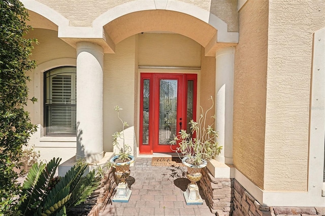 entrance to property with stucco siding