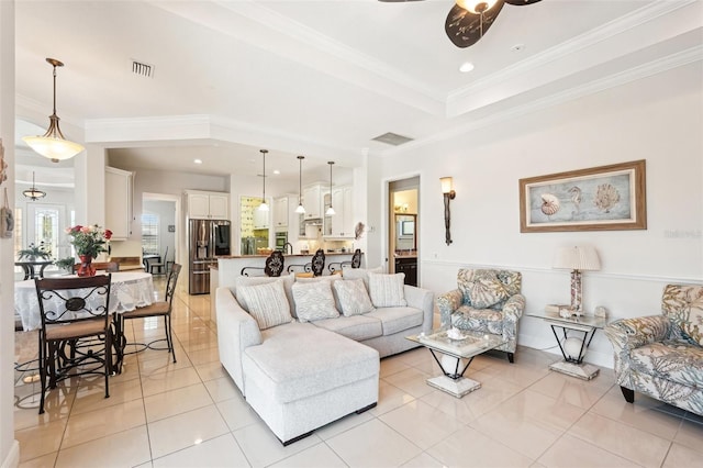 living area featuring light tile patterned floors, a ceiling fan, visible vents, recessed lighting, and crown molding