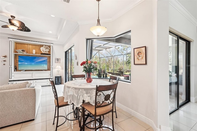 dining area with light tile patterned flooring, crown molding, baseboards, and a sunroom