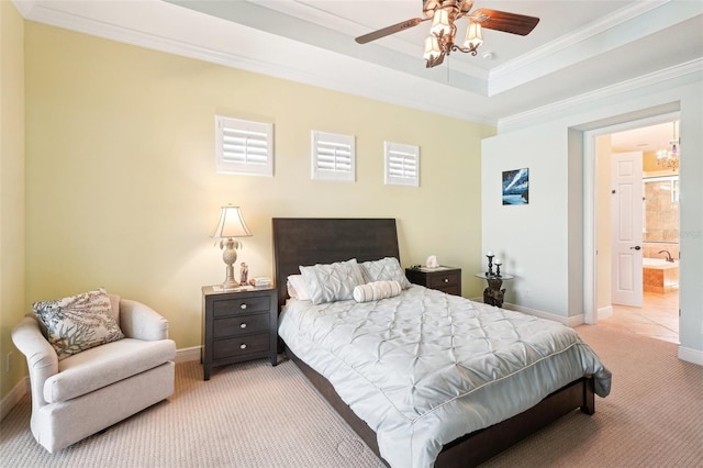 bedroom featuring baseboards, ensuite bath, a tray ceiling, light carpet, and crown molding