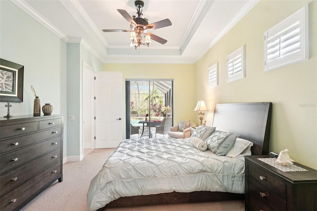 bedroom featuring a tray ceiling, light carpet, access to exterior, and ornamental molding