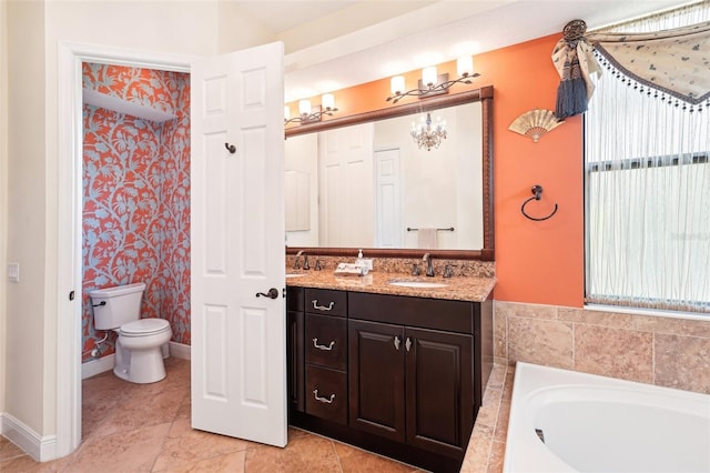 full bath featuring a garden tub, toilet, baseboards, a chandelier, and vanity