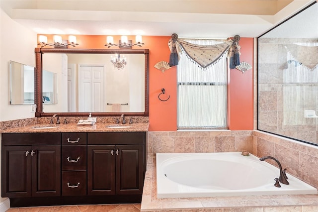 bathroom featuring a bath, double vanity, tiled shower, and a sink